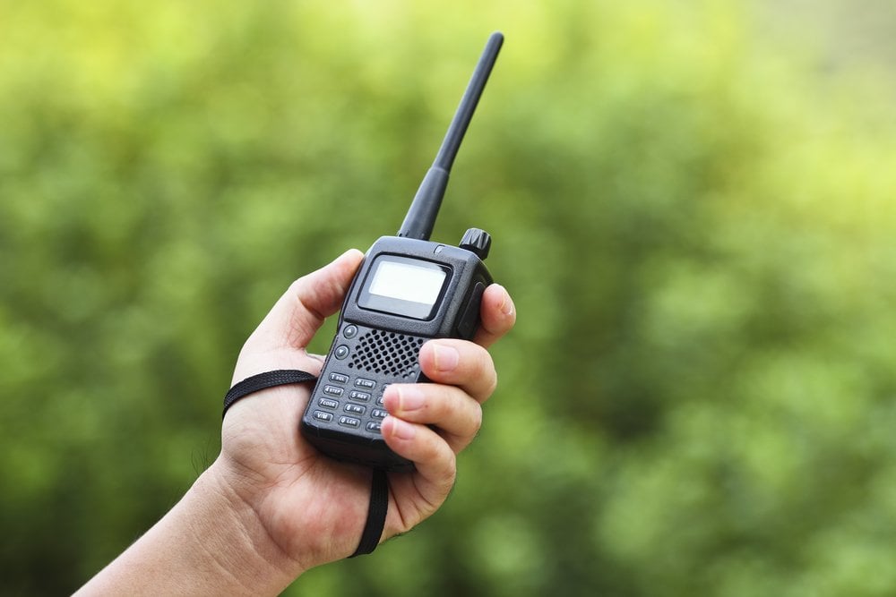 Handheld radio grasped in left hand Handheld radio grasped in left hand